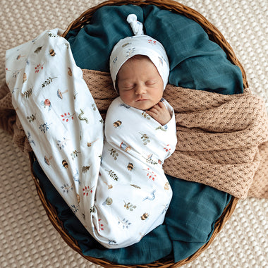 Baby wrapped in Garden Friends Organic Jersey Wrap & Beanie Set