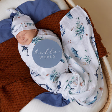 Baby wrapped in Ocean Organic Muslin Wrap | Snuggle Hunny