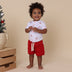 Toddler wearing Red Organic Shorts | Snuggle Hunny